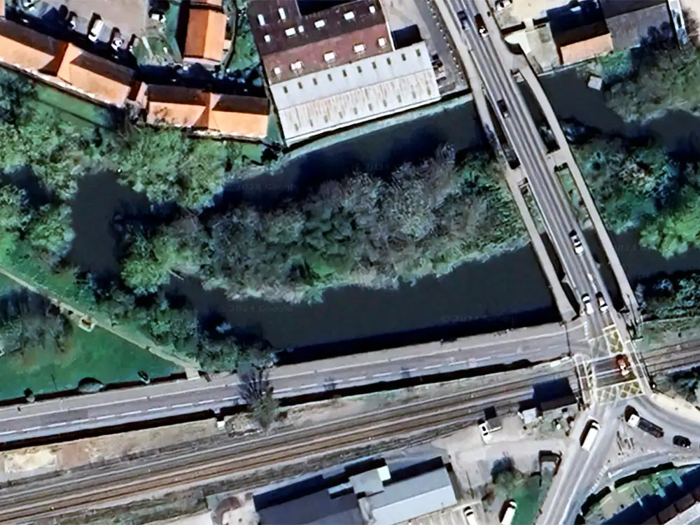 Woman stumbles down embankment and ends in river