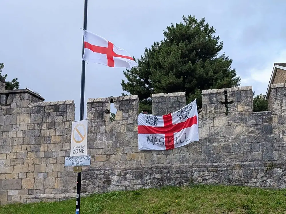 Man arrested after flag with threatening message placed on York city walls