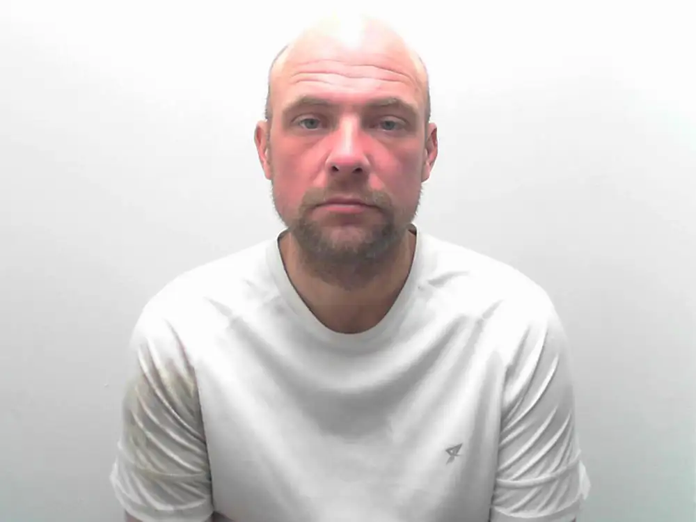 Drunken burglar who waved at CCTV camera jailed