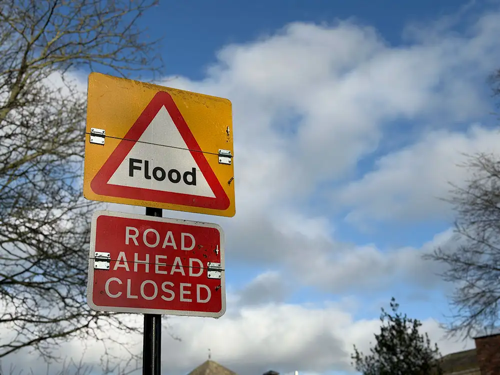 Rescued: Person sitting on roof of car submerged in flood water in York village