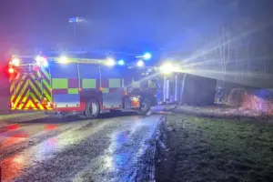 Driver trapped in cab after lorry carrying livestock overturns
