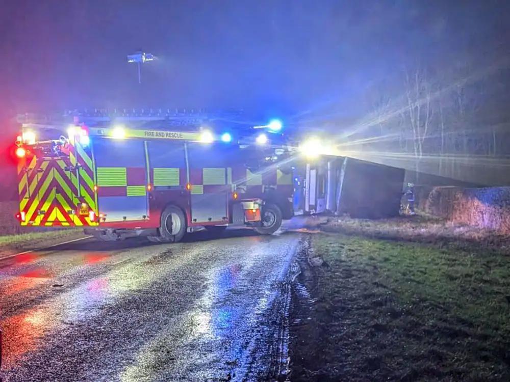 Driver trapped in cab after lorry carrying livestock overturns