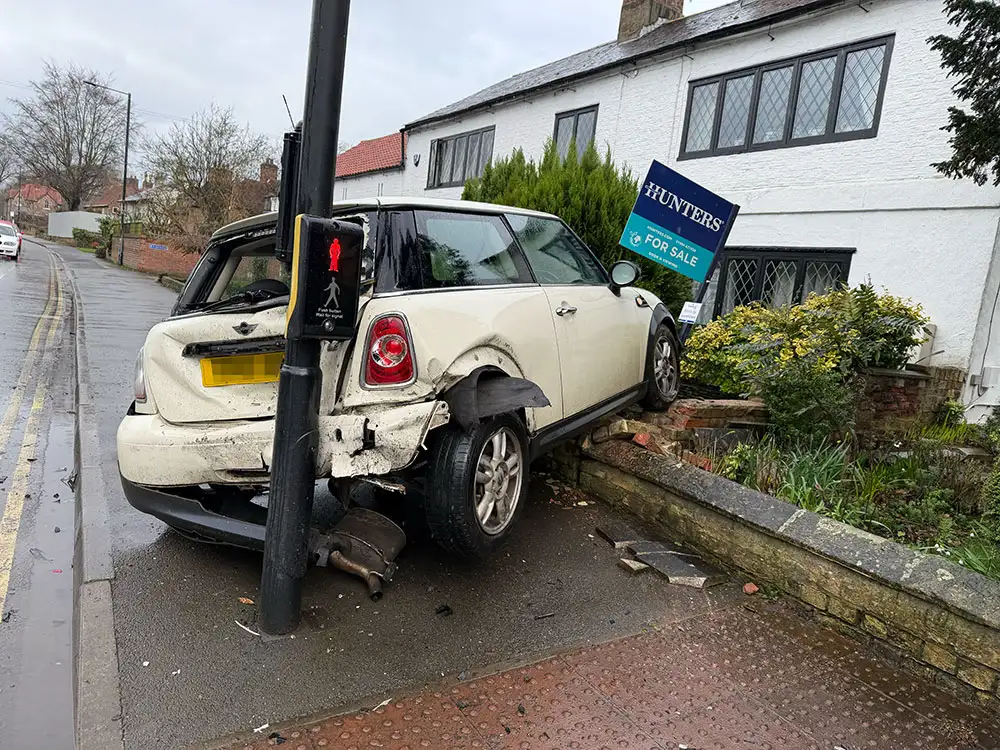 Car crashes into garden at busy York junction