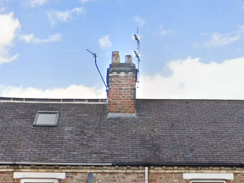 Firefighters remove TV ariel hanging in dangerous position from York house
