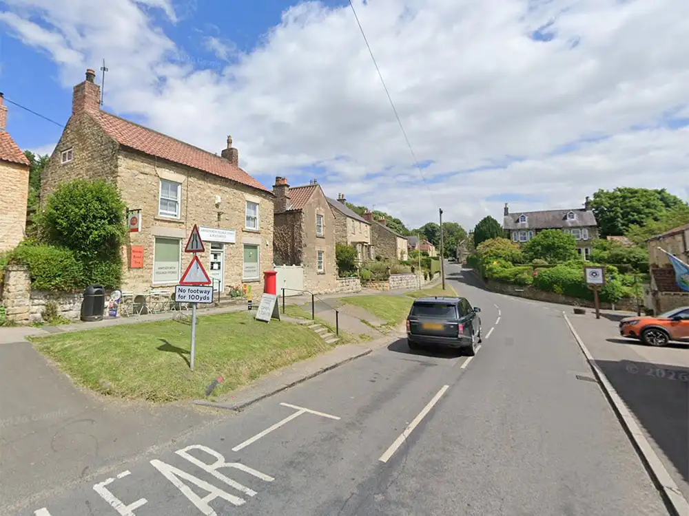 Vehicle ends up on its side after crashing into parked cars in North Yorkshire village